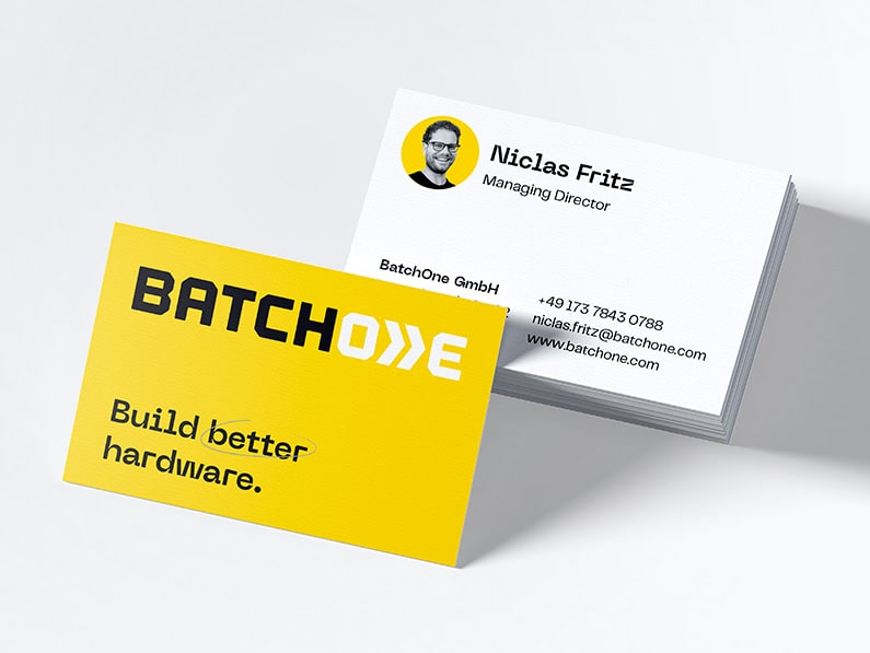business card design with logo and claim on a bright yellow front and text on back